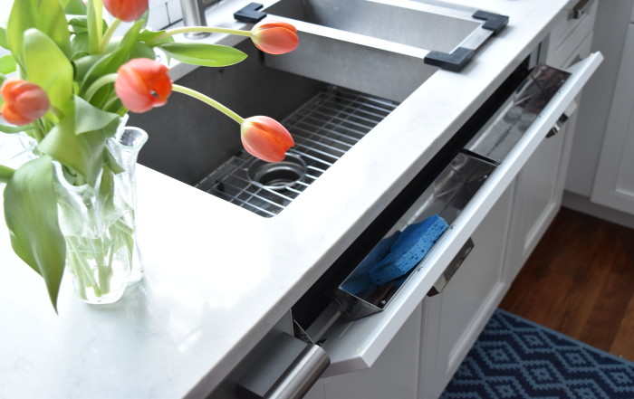 Tilt Tray at the sink front to hold sponges + clothes